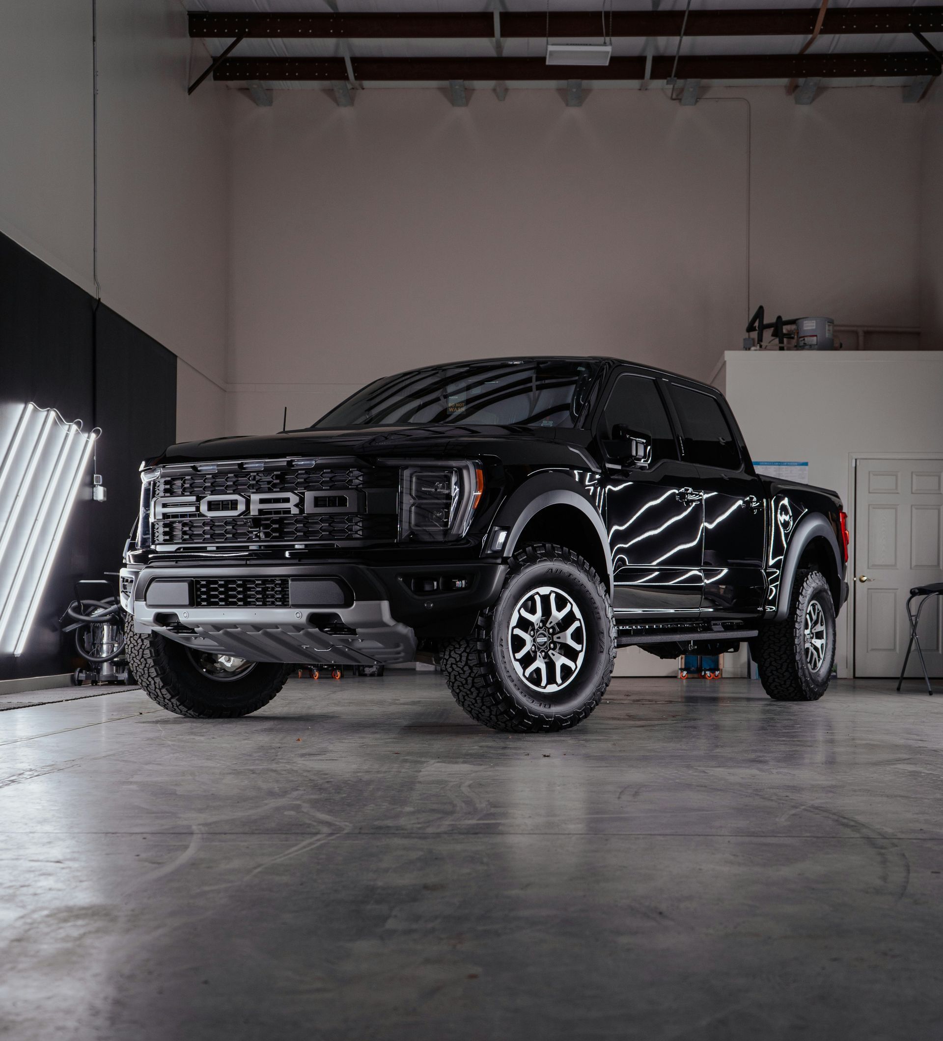 a black truck parked inside of a garage