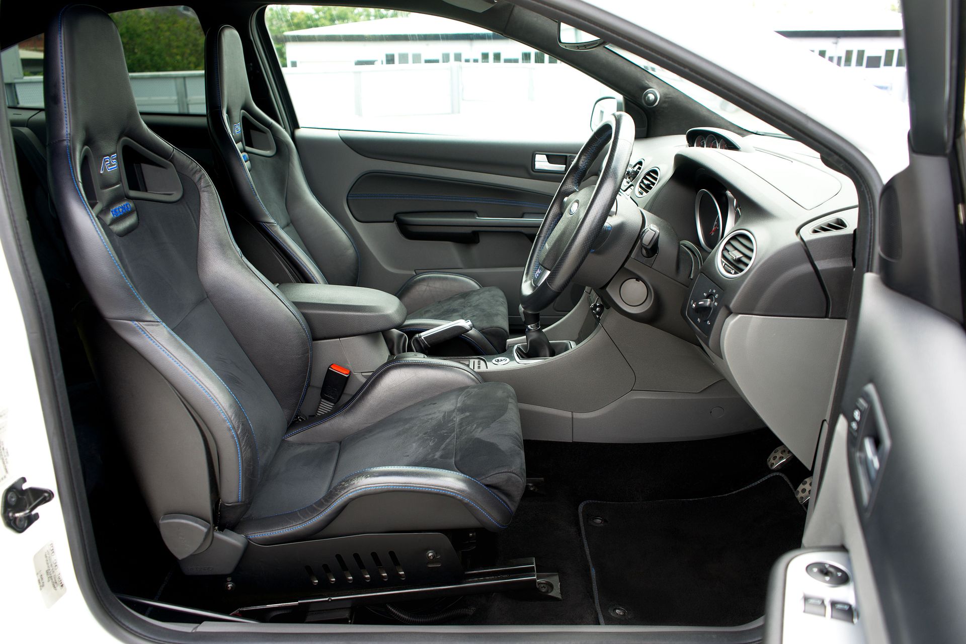 Luxurious car interior featuring leather seats and dashboard, showcasing comfort and style.